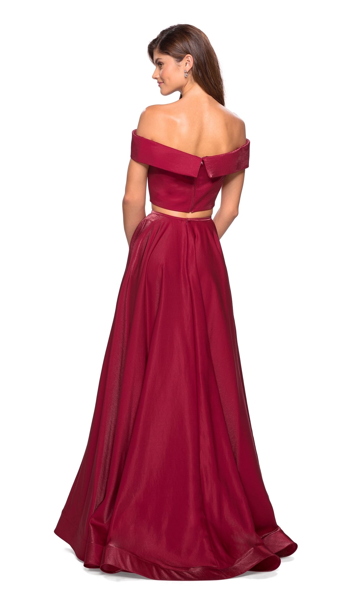 A woman faces away, wearing the La Femme A-Line Two-Piece Satin Prom Dress 26919, featuring a burgundy satin finish, off-the-shoulder neckline, fitted bodice, and full a-line silhouette.